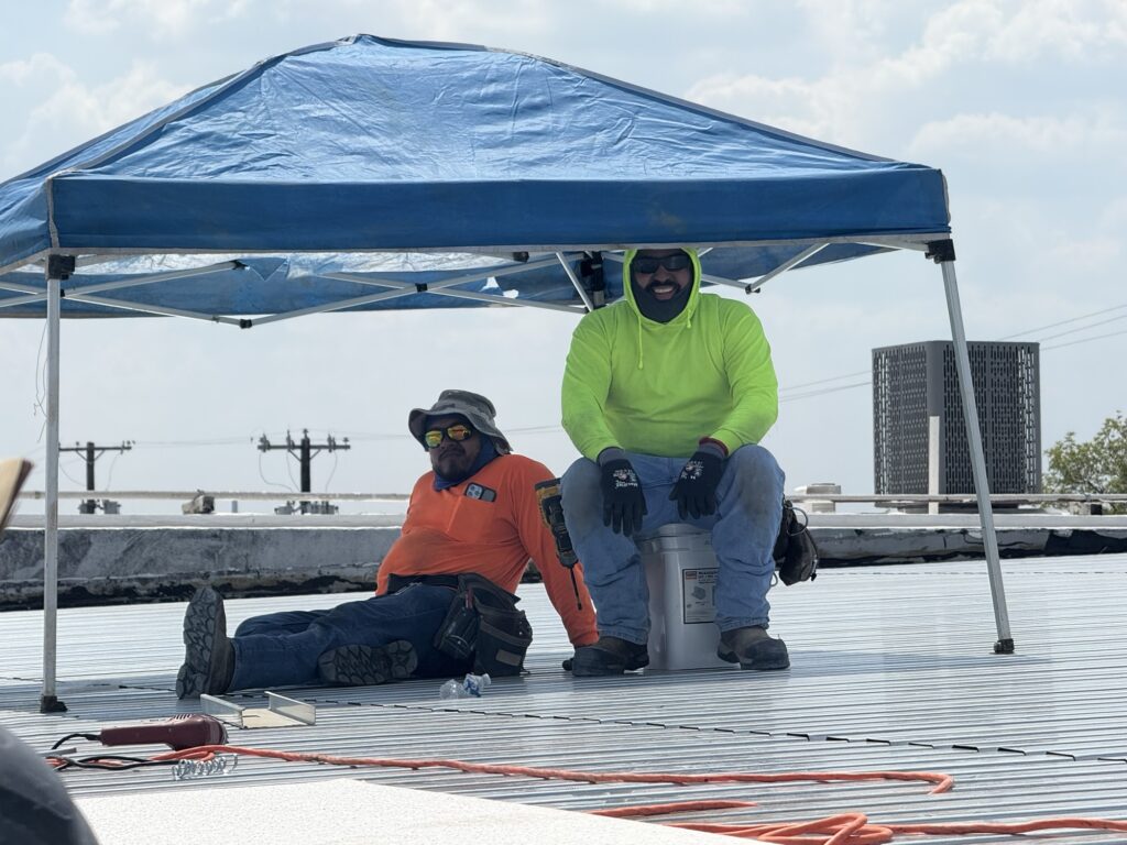 Two of our trade partners take a quick break in some shade while working on the Kitchen Dog Theater remodel in Dallas