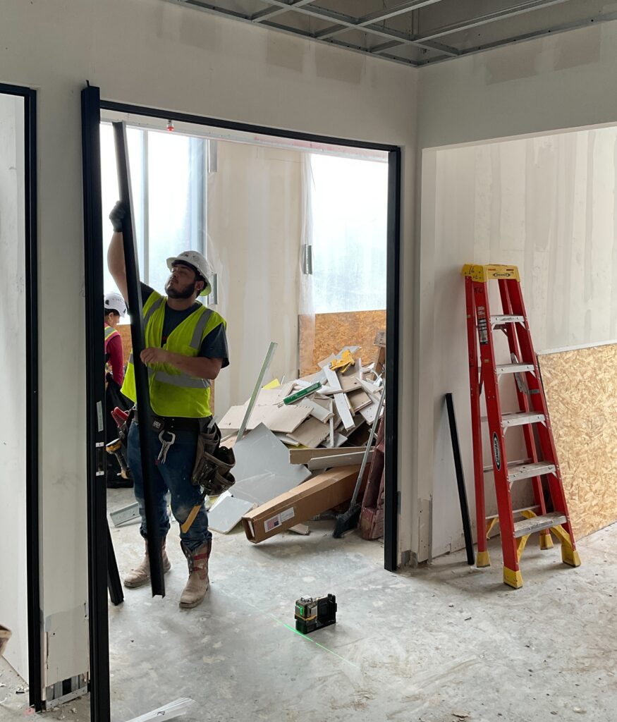 Trade partner working on interior framing at The Birchman Office Buiding in Fort Worth