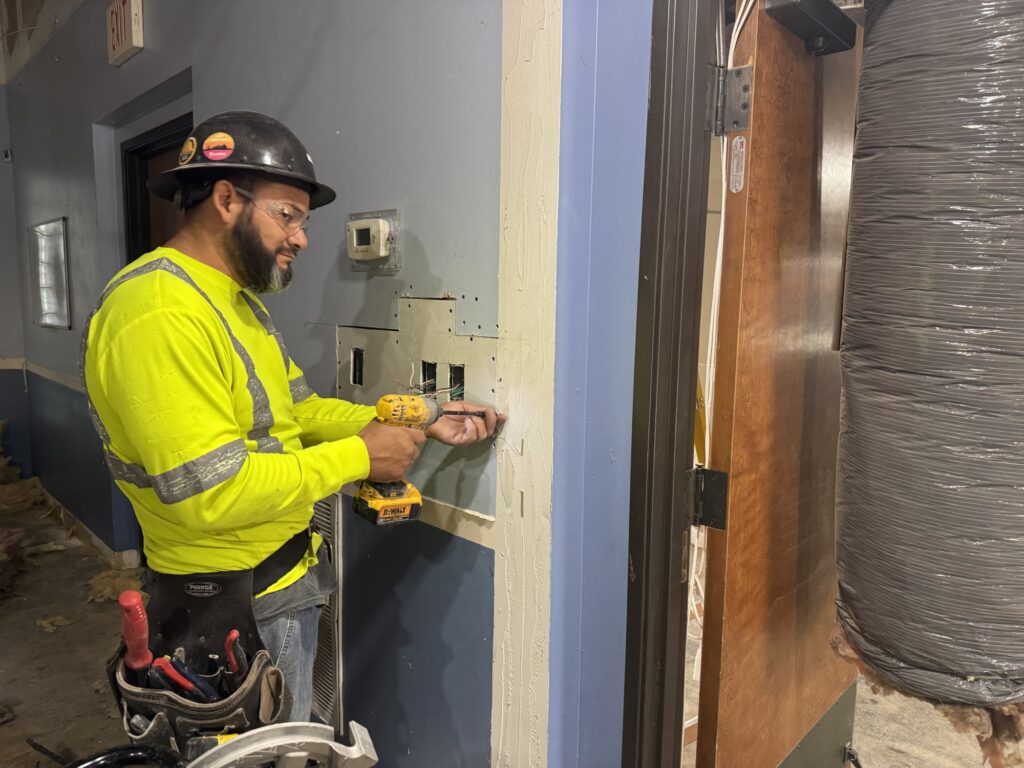 Electrician working on interior of Emmanuel Chin Baptist Church in Lewisville, Texas