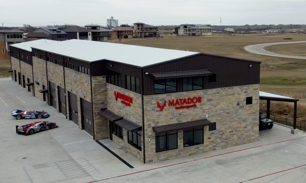 Exterior aerial view of Matador Motorsports mixed-use building in Cresson, Texas